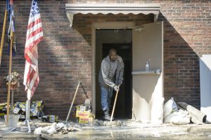 Ricardo Williams sweeps water from the the flood-damaged fellowship hall at Hope Mills United Methodist Church on Thursday, Oct. 13, 2016. The hall was flooded by Hurricane Matthew.